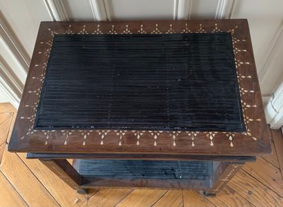 A veneer and mother of pearl inlaid saddle.

In...