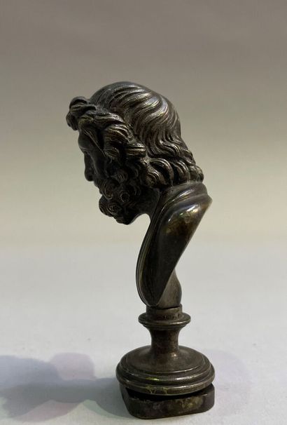 Bronze seal surmounted by a bust of Zeus.
End...