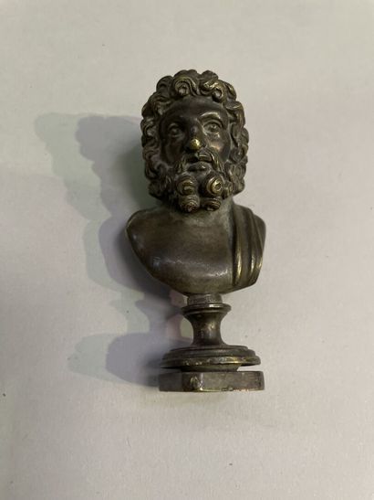 Bronze seal surmounted by a bust of Zeus.
End...