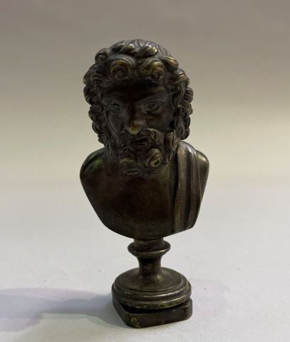 Bronze seal surmounted by a bust of Zeus.
End...