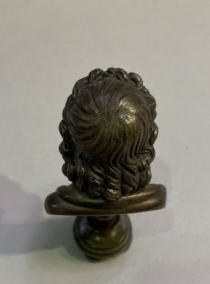 Bronze seal surmounted by a bust of Zeus.
End...
