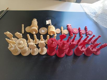 Carved and stained ivory chess set including...