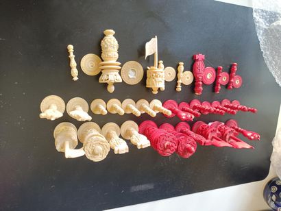 Carved and stained ivory chess set including...