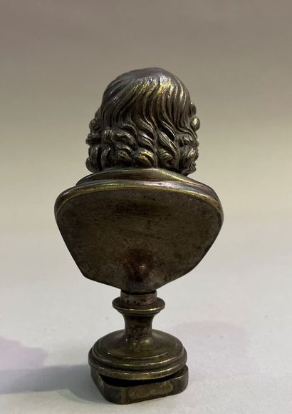 Bronze seal surmounted by a bust of Zeus.
End...