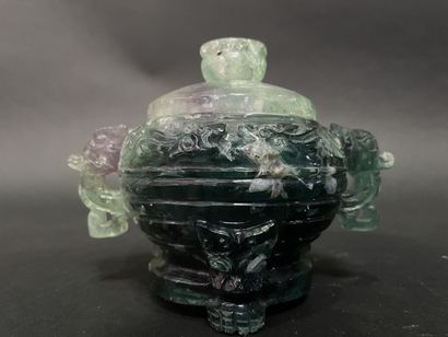Covered pot, the handles in the shape of...