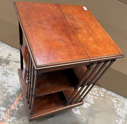 Revolving bookcase in stained wood. 
Beginning...