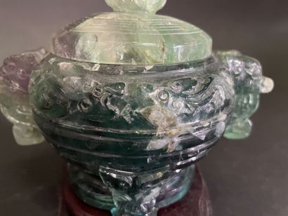 Covered pot, the handles in the shape of...