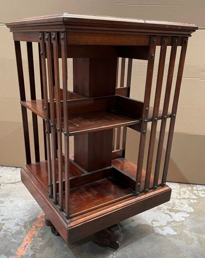 Revolving bookcase in stained wood. 
Beginning...