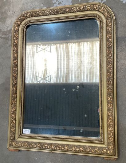 Gilded stucco mirror, the upper angles rounded,...