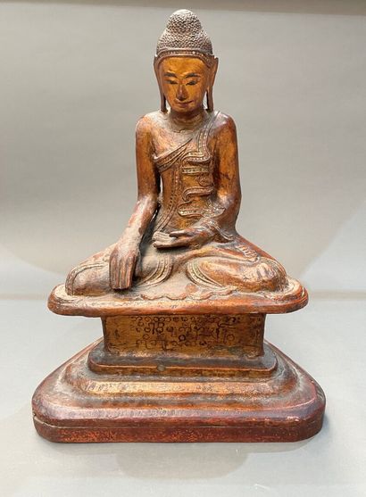 Seated Buddha in carved and gilded wood,...