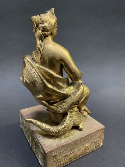 Bronze group representing a goddess sitting...