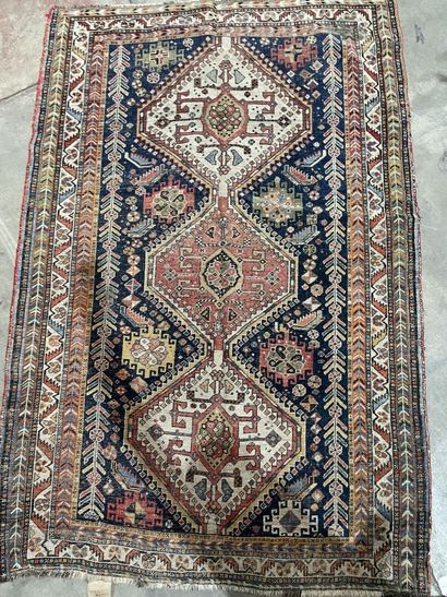 Woolen carpet decorated with three lacy lozenges...