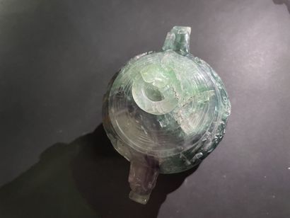 Covered pot, the handles in the shape of...