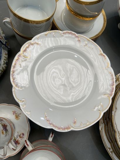 Part of a porcelain dinner service with gilded...