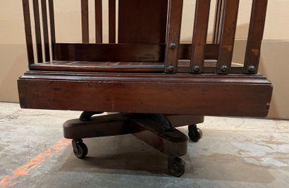 Revolving bookcase in stained wood. 
Beginning...
