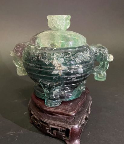 Covered pot, the handles in the shape of...