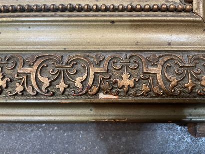Gilded stucco mirror, the upper angles rounded,...