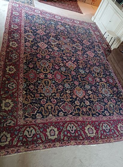Wool carpet decorated with scrolls on a navy...