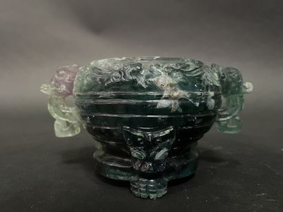 Covered pot, the handles in the shape of...