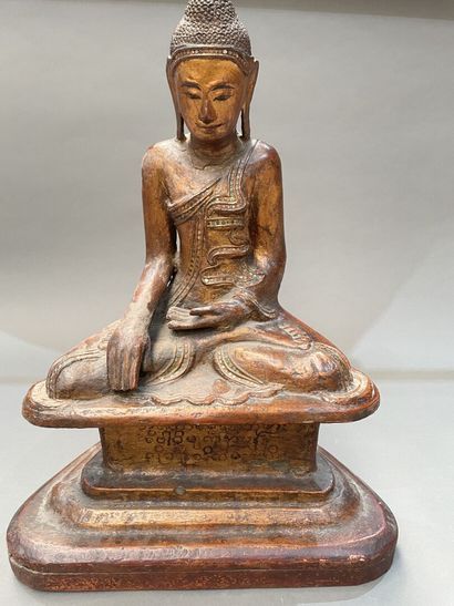 Seated Buddha in carved and gilded wood,...