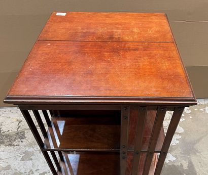 Revolving bookcase in stained wood. 
Beginning...