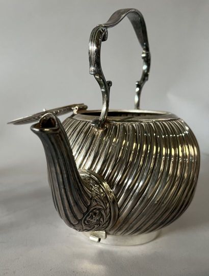 English silver-plated teapot on stove with...