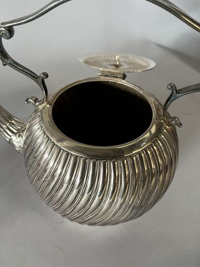 English silver-plated teapot on stove with...