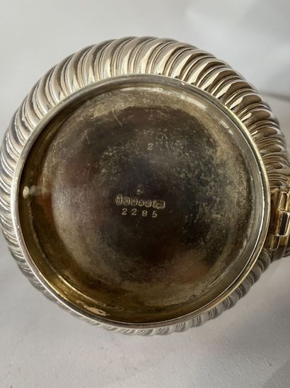 English silver-plated teapot on stove with...
