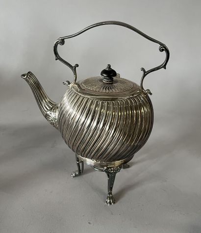 English silver-plated teapot on stove with...