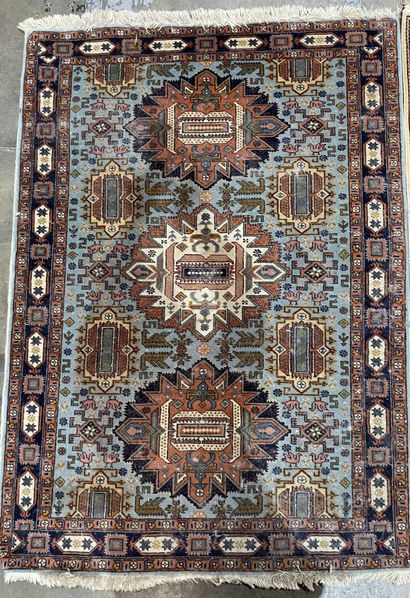 Two rugs : 
- an oriental silk carpet on...