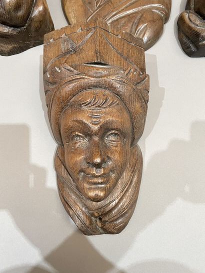 Three heads in high-relief carved natural...