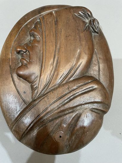 Three heads in high-relief carved natural...
