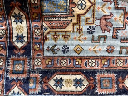 Two rugs : 
- an oriental silk carpet on...
