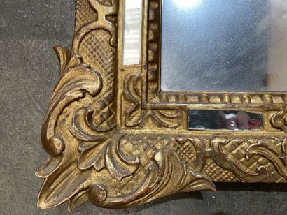 Small giltwood mirror carved with a flowery...