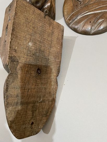 Three heads in high-relief carved natural...