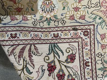 Two rugs : 
- an oriental silk carpet on...