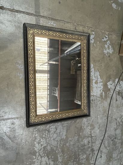 Blackened pearwood mirror with gilded fishnet...