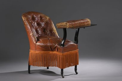 Curieux fauteuil en cuir capitonné havane...