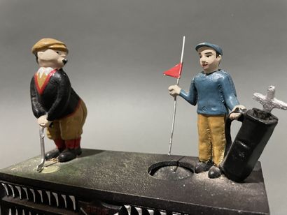 Groupe en fonte peinte, golfeur et son caddie
Travail...