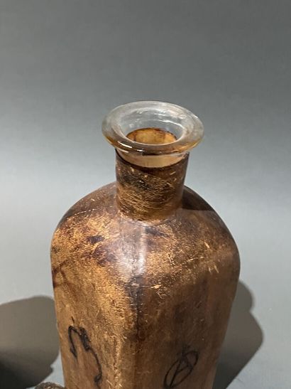 Deux bouteilles en verre gaînées de cuir...