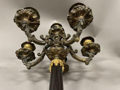 Pair of tripod candelabra in patinated and...