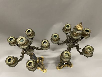 Pair of tripod candelabra in patinated and...