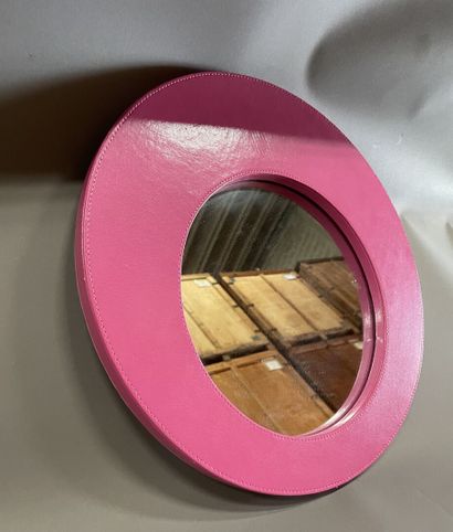 Round mirror with pink leather-wrapped f...