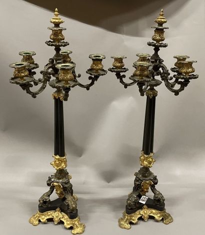 Pair of tripod candelabra in patinated and...