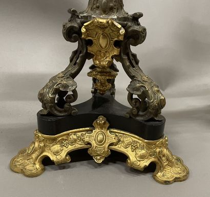 Pair of tripod candelabra in patinated and...