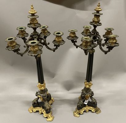 Pair of tripod candelabra in patinated and...