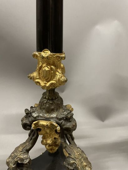 Pair of tripod candelabra in patinated and...