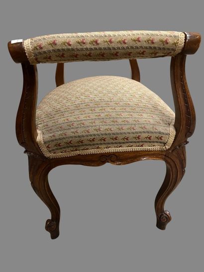 Molded and carved natural wood stool resting...