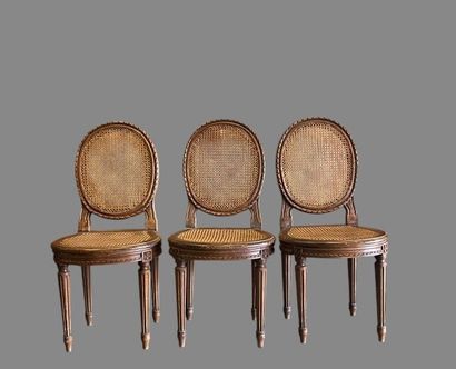 Three caned chairs in molded natural wood....