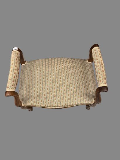 Molded and carved natural wood stool resting...
